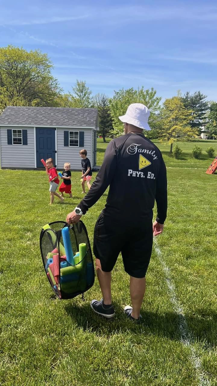 A Family Phys. Ed. coach and children enjoying games