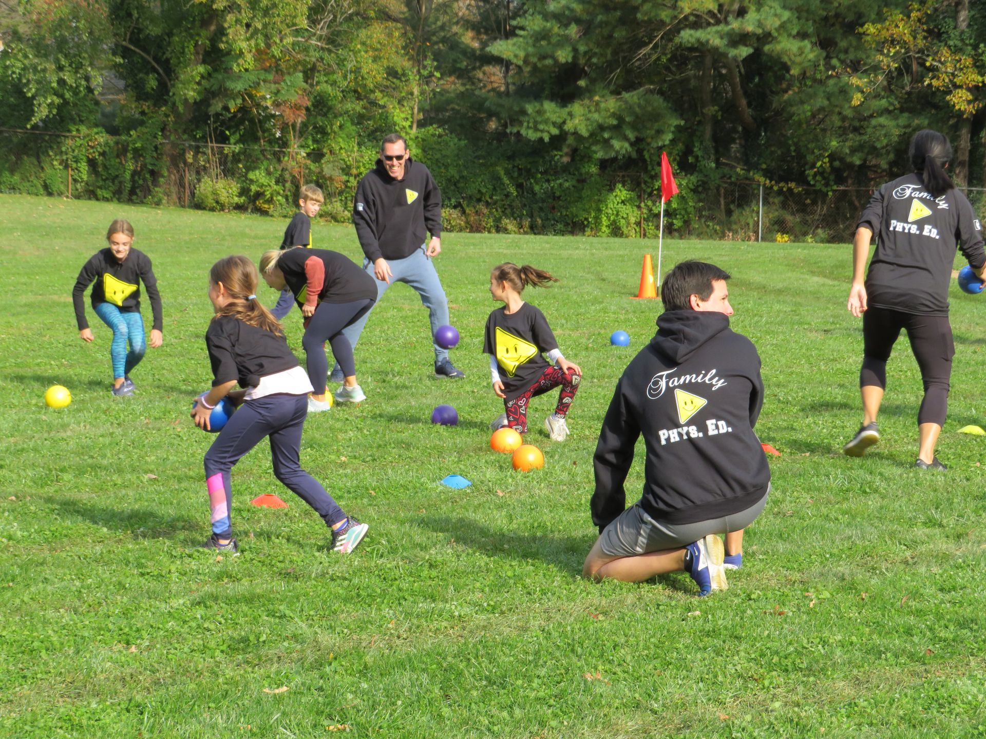 A large group of families playing together in a community P.E. class